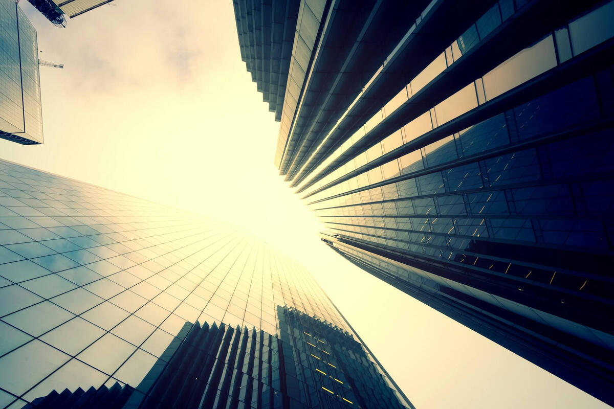 Data Center Capital Investment Corporate skyscrapers viewed from below representing institutional capital expenditure